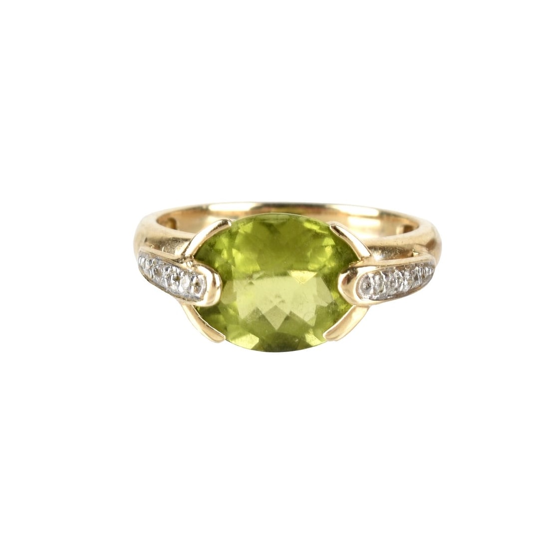 Peridot and 14K Ring: Oval Cut Peridot and 14 Karat Yellow Gold Ring Accented with Small Round Cut Diamonds. Stamped 14K. Ring size 5. Approx. weight: 3.0 grams. Condition: Very good condition. Estimate: $150.00 - $250.00 