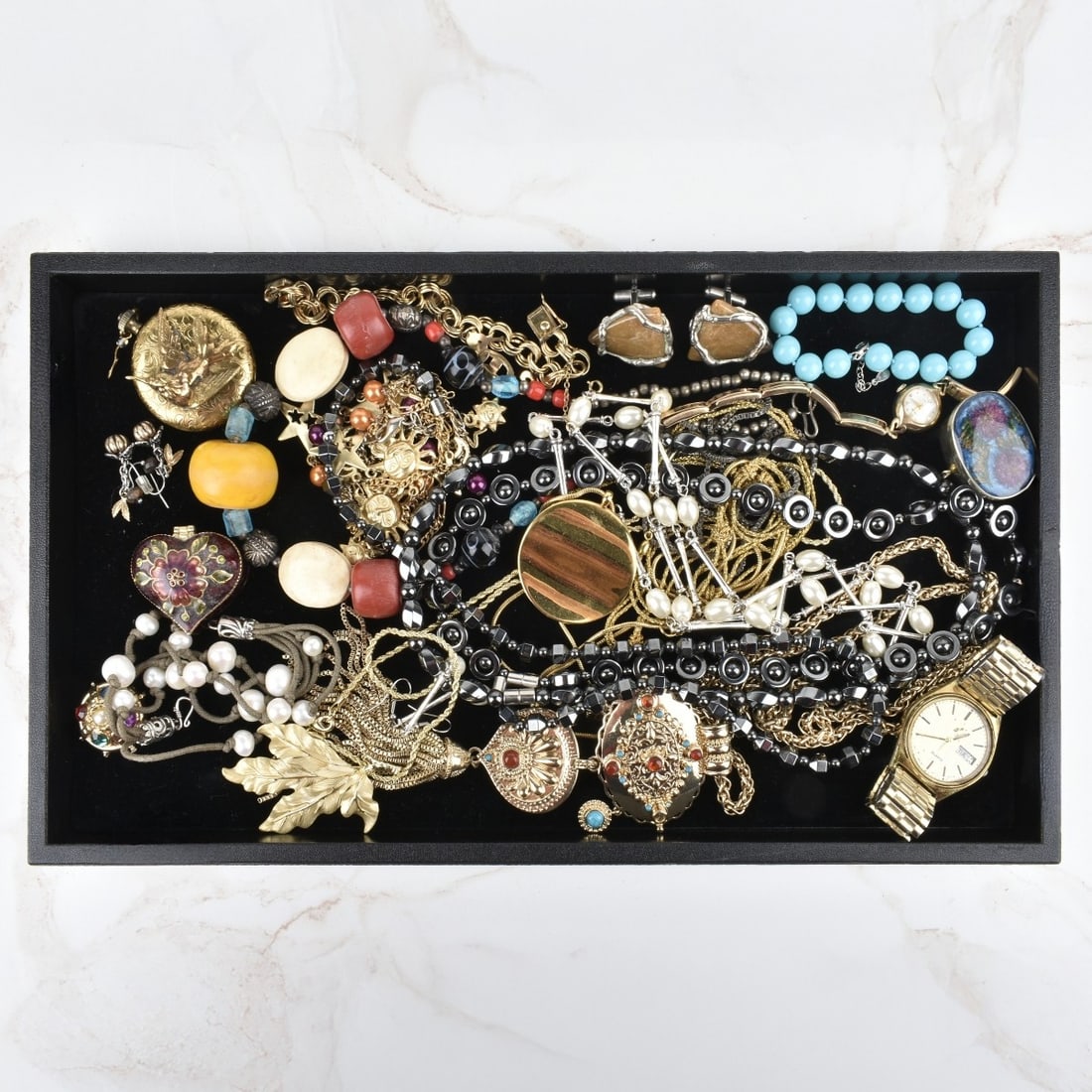 Fashion Jewelry: Tray Lot of Vintage Fashion Jewelry. To include necklaces, bracelets pendants, watches, pill boxes, cufflinks and more. Various styles and makers. Kodner Galleries offers phone and absentee bidding at