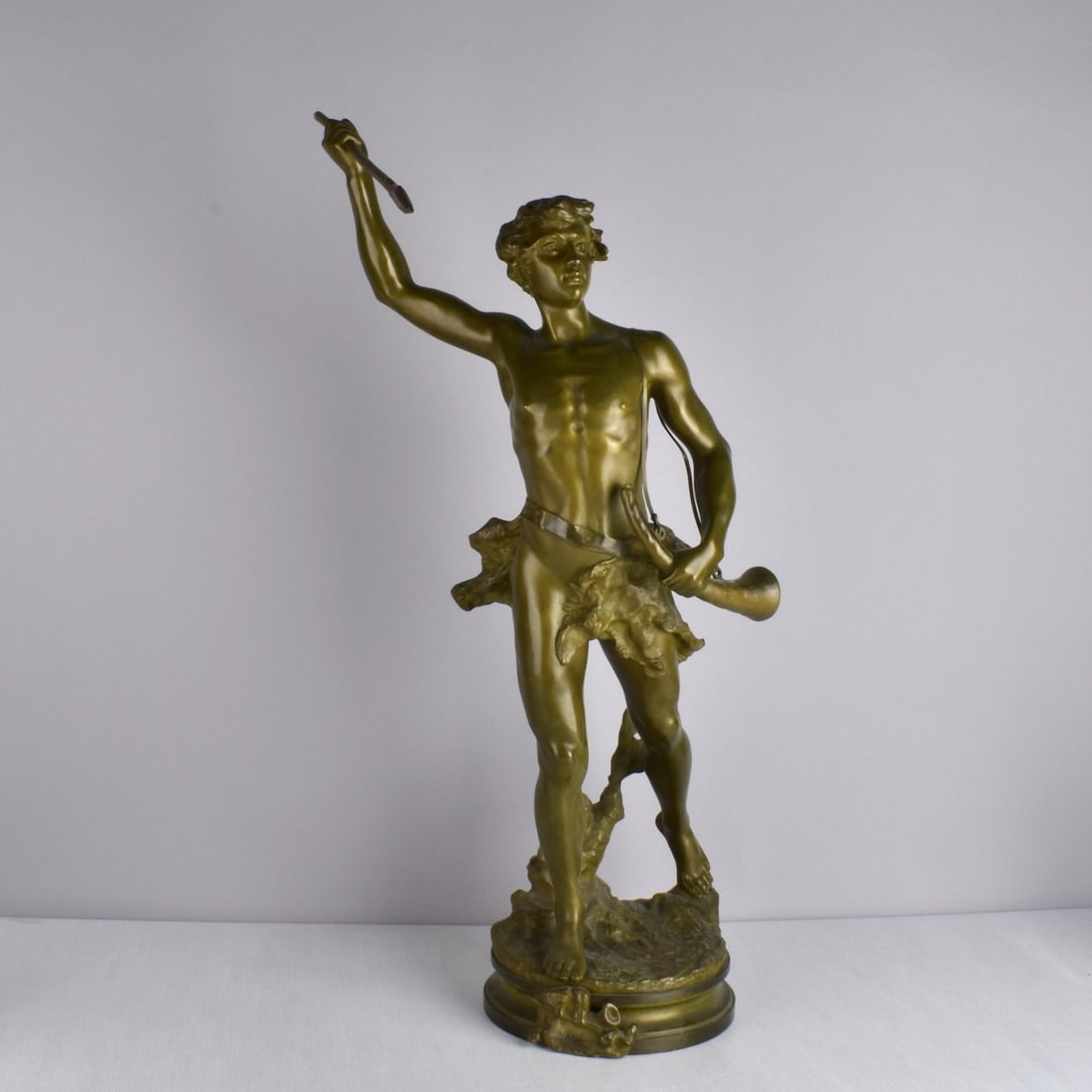 Adrien Etienne Gaudez (French:1884-1902): Adrien Etienne Gaudez (French:1884-1902). A Bronze Figure Titled "Acteon". A hunter with his spear ready to throw as well as a horn to his side in a rich verdigris patina. Attached front plaque in the