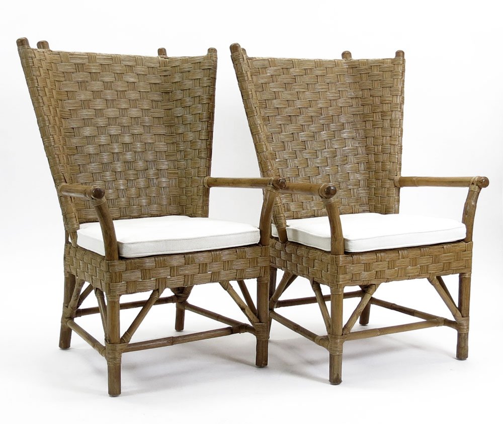 Pair of Contemporary Possibly Palecek Orkney-style Ratt: Pair of Contemporary Possibly Palecek Orkney-style Rattan Arm Chairs with Loose Cushion Seats. Unsigned. Measure 44 Inches Tall, 31 Inches Wide and 28 Inches Deep. We will not ship this item due to it