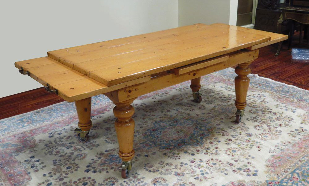 Contemporary Italian Guido Zichele for Bloomingdale's F: Contemporary Italian Guido Zichele for Bloomingdale's Farm-style Pine Plank Draw Leaf Table with Large Casters. Signed to Underside. Rubbing to Surfaces Otherwise Good Condition or Better. Measures Cl