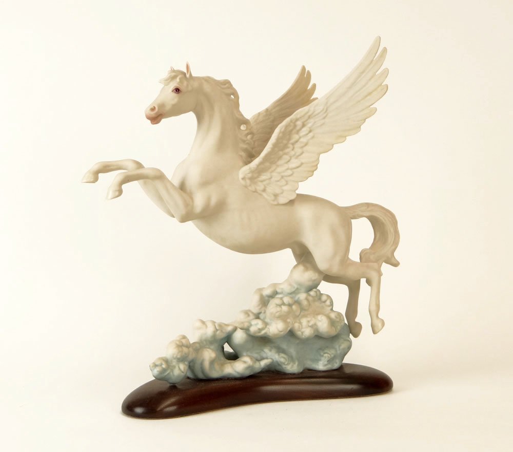 Cybis Bisque Porcelain "Pegasus" Figure Hand Painted an: Cybis Bisque Porcelain "Pegasus" Figure Hand Painted and Attached to Wooden Base. Signed Rear of Sculpture. Very Good Condition. Measures almost 13-3/8 Inches Tall and 13 Inches Long Including Base. S