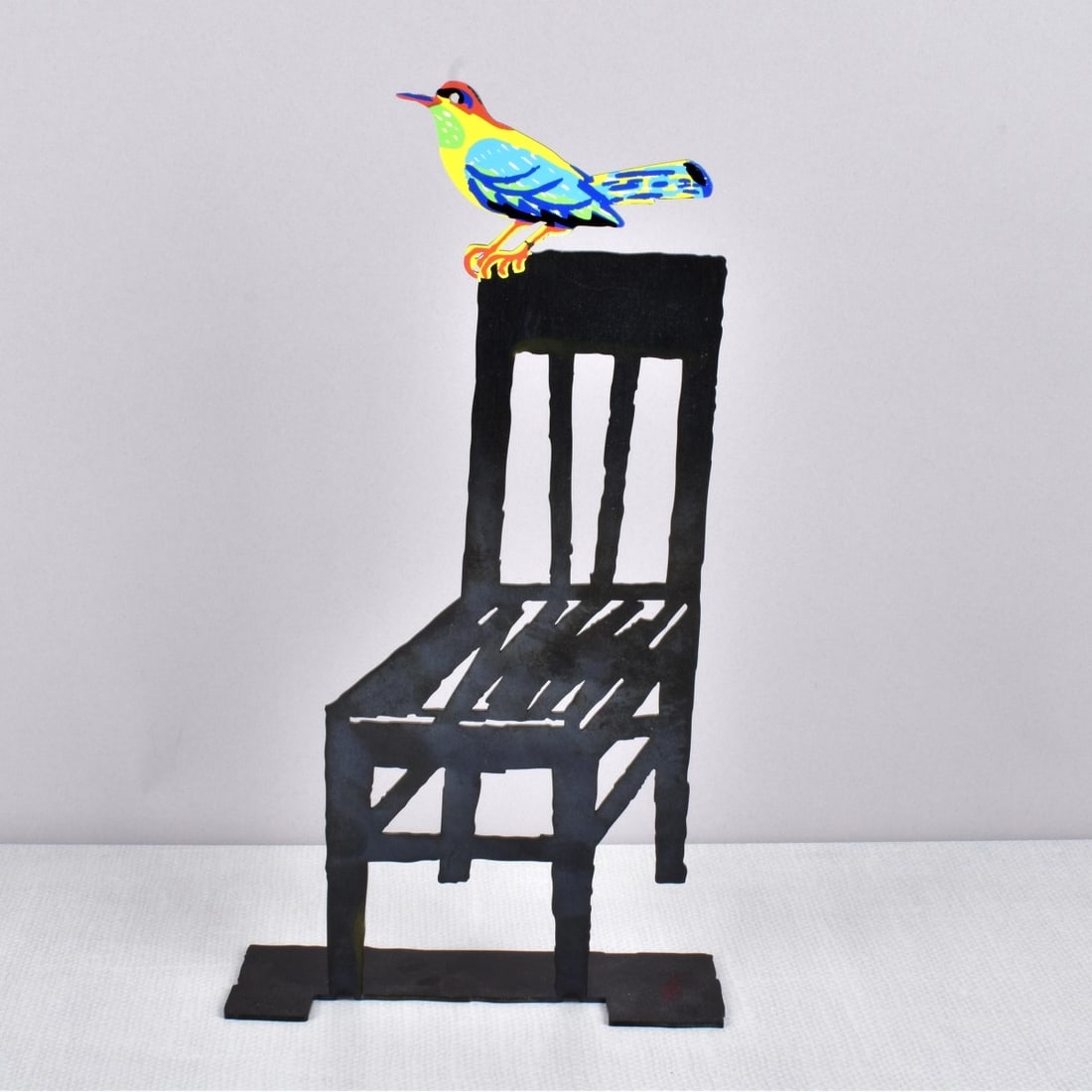 David Gerstein, Israeli (b. 1944): David Gerstein, Israeli (b. 1944) Painted Metal Cut Out Figural Sculpture of a Small Bird Perched on the Corner of a Chair. Artist signed. Measures: 12-1/4" H, 6-1/2" W, 2-3/8" D. Kodner Galleries off