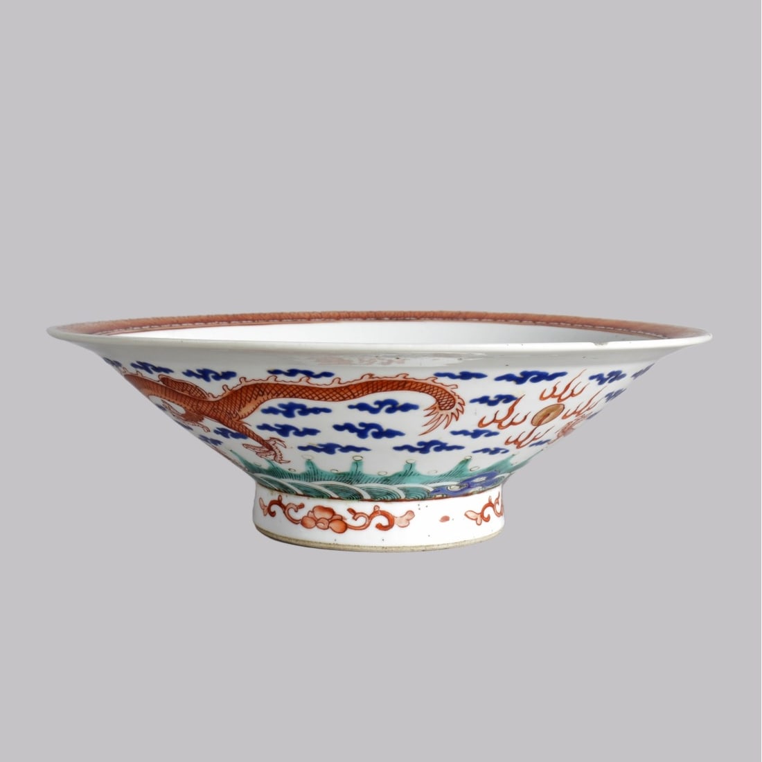 19C Chinese Famille Rose Dragon Bowl: 19th Century Chinese Famille Rose Dragon Footed Bowl. Dragon in sky over water with Koi Fish decoration to interior of bowl. Measure: 3" High, 10" Diameter. Kodner Galleries offers phone and absentee 
