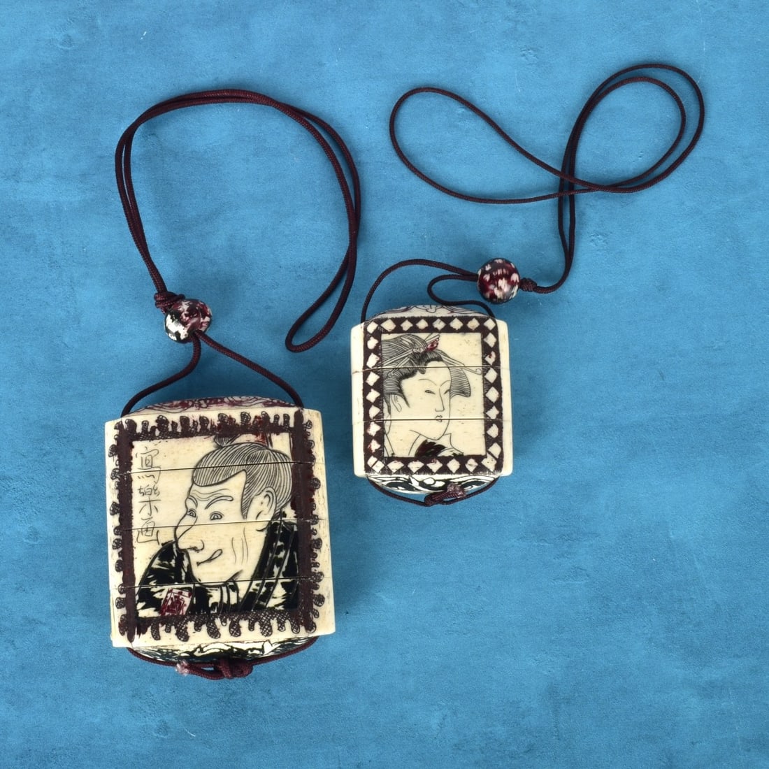 Japanese Enro Etched Pill Boxes: Two (2) Antique Japanese Enro Etched and Polychromed Pill Boxes. One (1) with two (2) compartments, one (1) with three (3) compartments, both with draw strings and balls. Late 19th century. Largest me