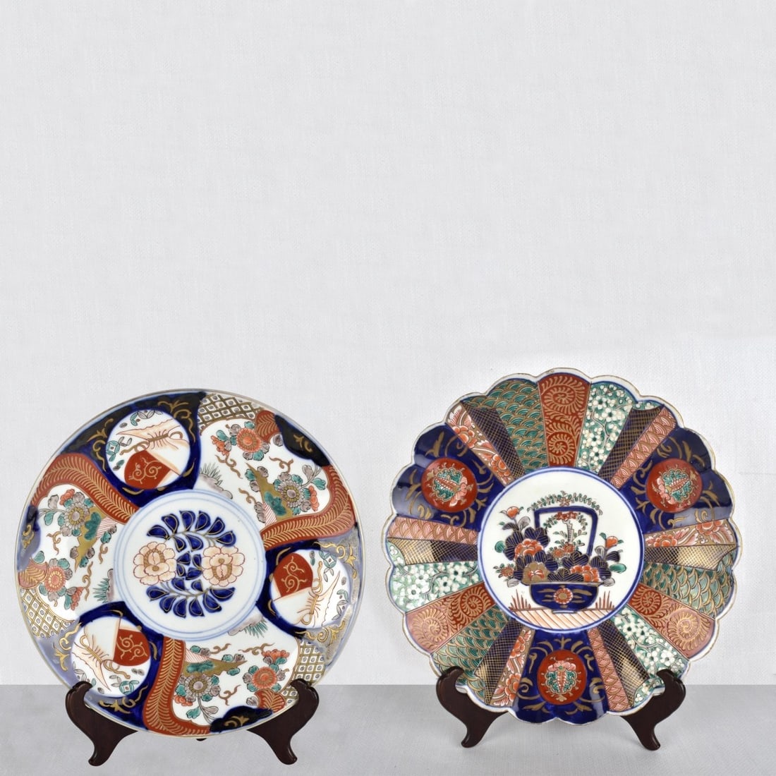 Japanese Imari Porcelain Chargers: Two (2) Japanese Imari Porcelain Chargers. Late 20th century. Measures: 2" H, 12" Dia. Kodner Galleries offers phone and absentee bidding at a low, flat 21% buyer’s premium without surcharge or hidd
