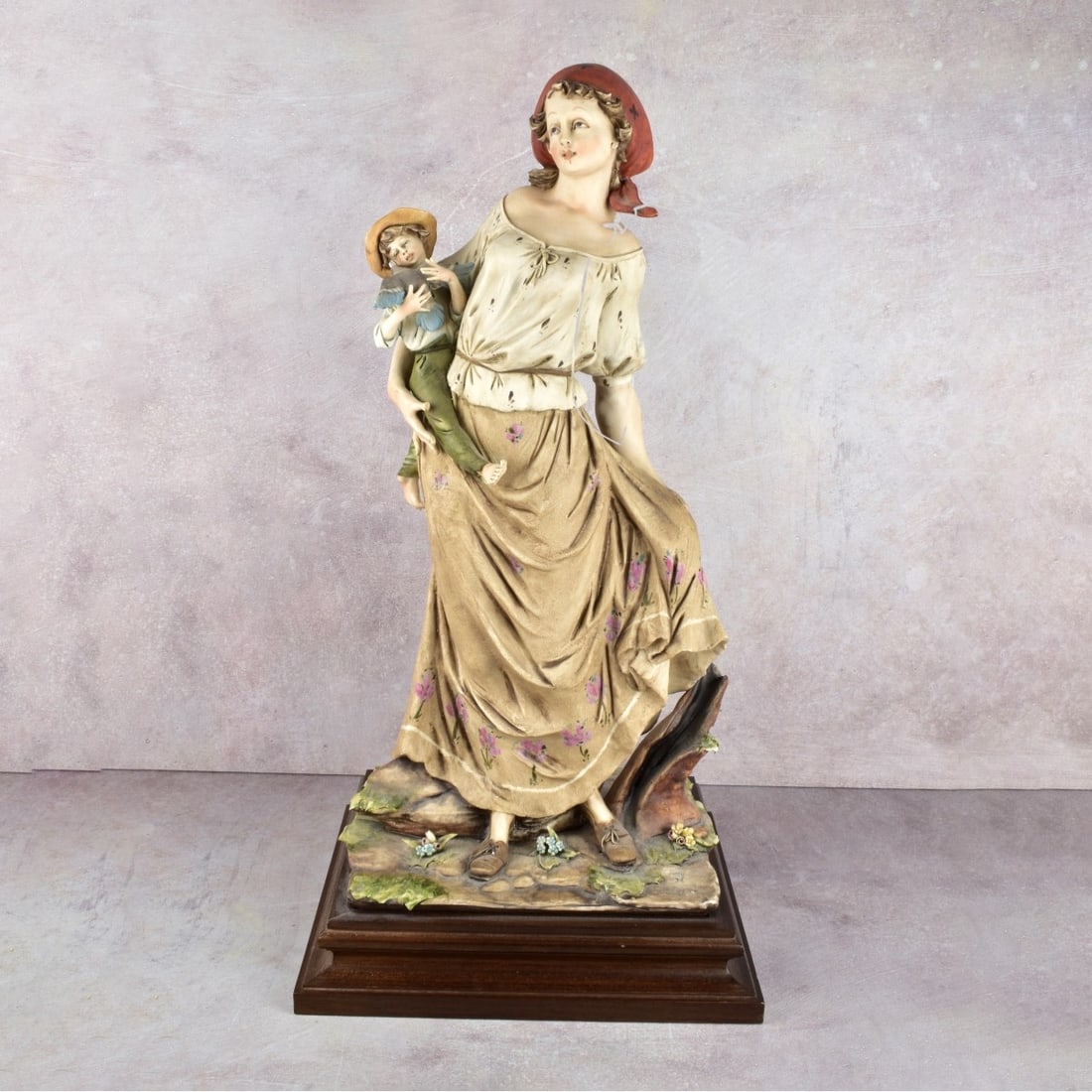 Italian Capodimonte Porcelain Figure: Italian Capodimonte Porcelain Figure of a Mother Holding a Young Child. Mounted on a Wood Base. Signed "G. Pellati". Overall measures: 22" H, 11" W, 9-1/2" D. Kodner Galleries offers phone and absente
