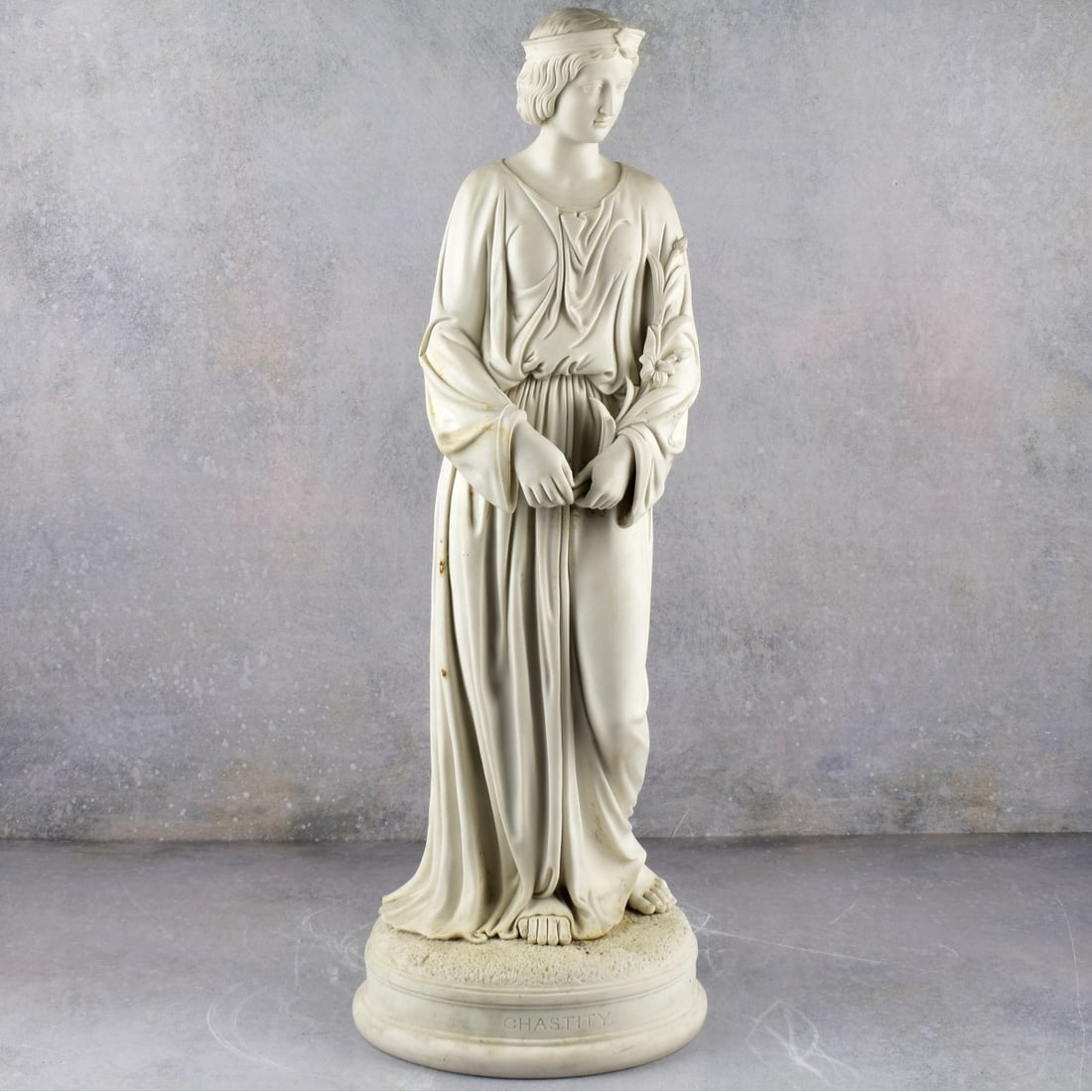 Parian "Chastity" Sculpture: Vintage Parian Porcelain Neo-classical "Chastity" Sculpture Standing Figurine Holding a Bunch of Flowers. Measures: 25" High, 5" Wide, 7" Deep. Kodner Galleries offers phone and absentee bidding at a