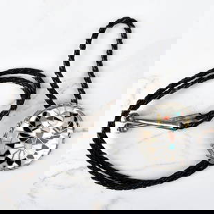 Zuni Hardstone and Silver Bolo Tie: Vintage Zuni Mother of Pearl, Black Onyx, Red Coral, and Turquoise and Sterling Silver Bolo Tie with Braided Leather. Signed "RLK", stamped sterling. Slider measures 2" diam; tie measures 36" L.