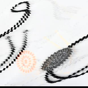 Native American Coral and Silver Bolo Tie: Vintage Native American Red Coral and Silver Bolo Tie with Braided Leather. Signed A. Q.. Slider measures 2-3/8" H, 2-1/4" W; tie measures 38" L. Approx. gross weight: 50.86 grams. Kodner Galleries