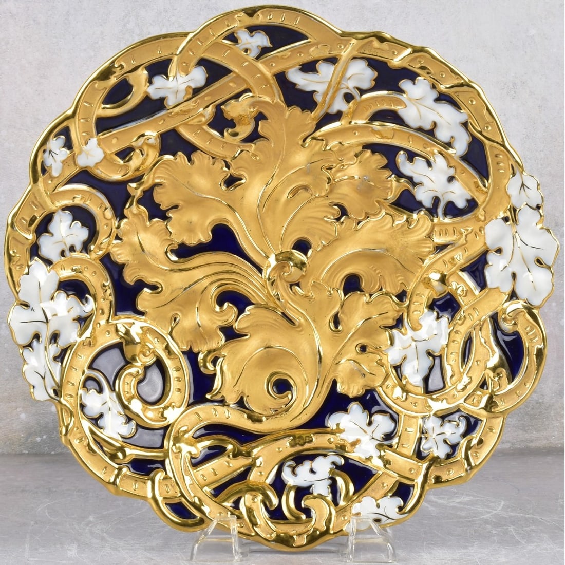 Meissen Porcelain Shallow Bowl: Meissen Porcelain Shallow Bowl With Heavy Gold Decoration with a Raised Foliage Edge. Marked with the Meissen crossed swords under glaze. Measures: 2-1/8" high, 11-1/4" diameter. Kodner Galleries offe