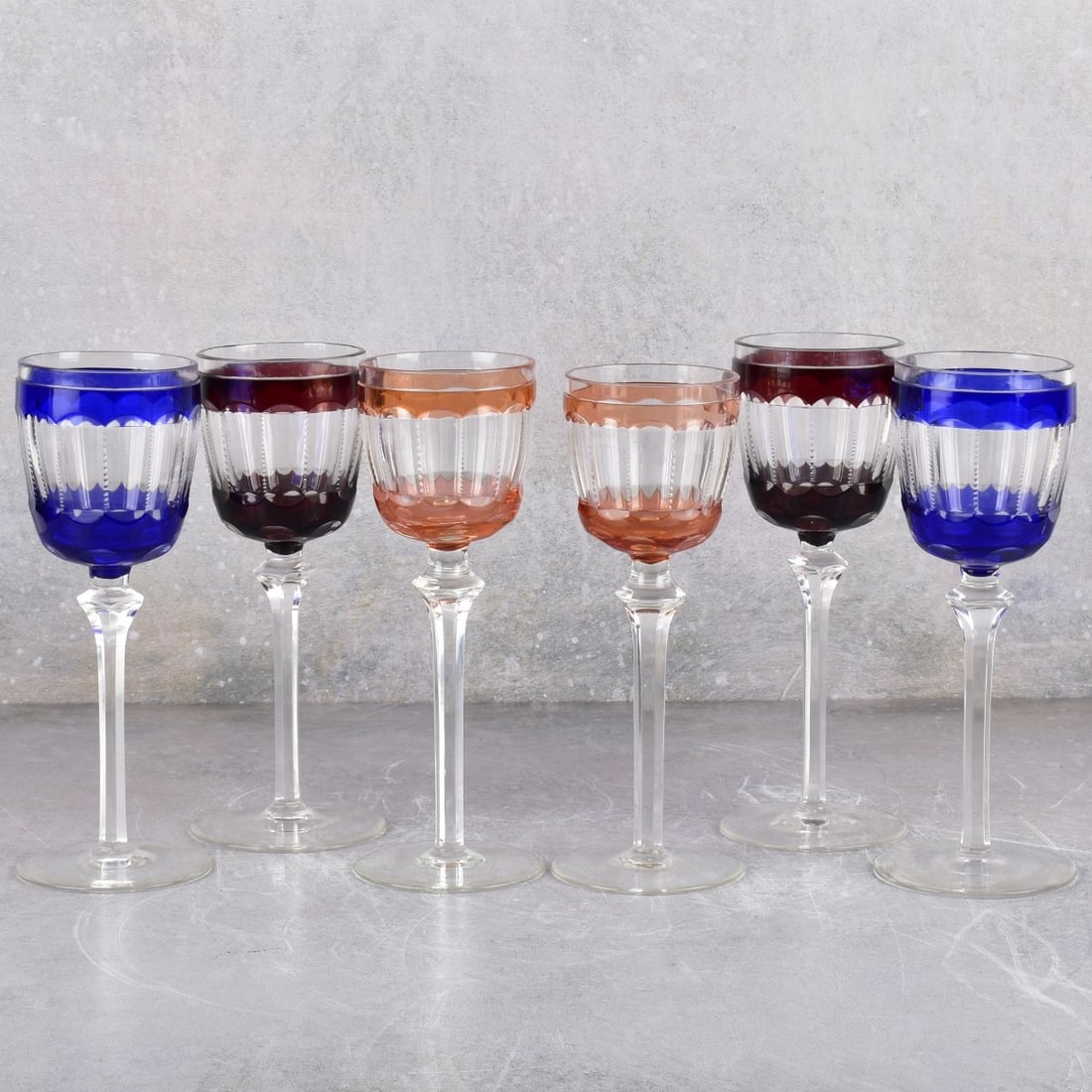 Crystal Wine Stemware Glasses: Six (6) Various Colors Crystal Stemware Glasses Cut to Clear. Two (2) each cobalt blue, ruby red and orange/pink. Tallest measures: 8-3/8" high, foot measures: 3-1/8", shortest measures: 8-1/4" high,