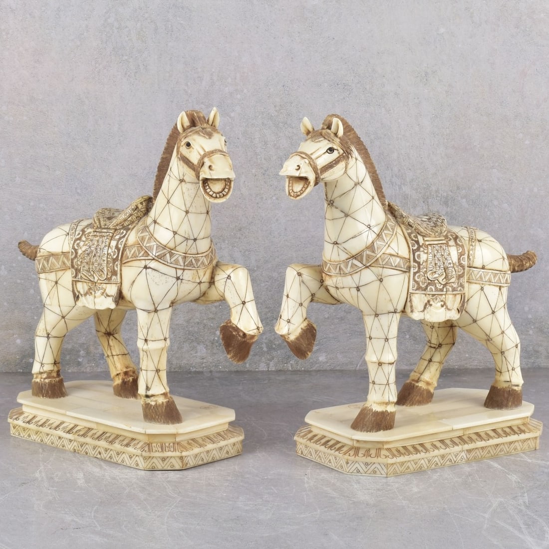 Carved Polychromed Bone Horse: Two Vintage Carved Polychromed Bone Horse Sculptures. Artist signed to the top of base. Measures: 10" high, 10" wide, 4" deep. Kodner Galleries offers phone and absentee bidding at a low, flat 21% buy