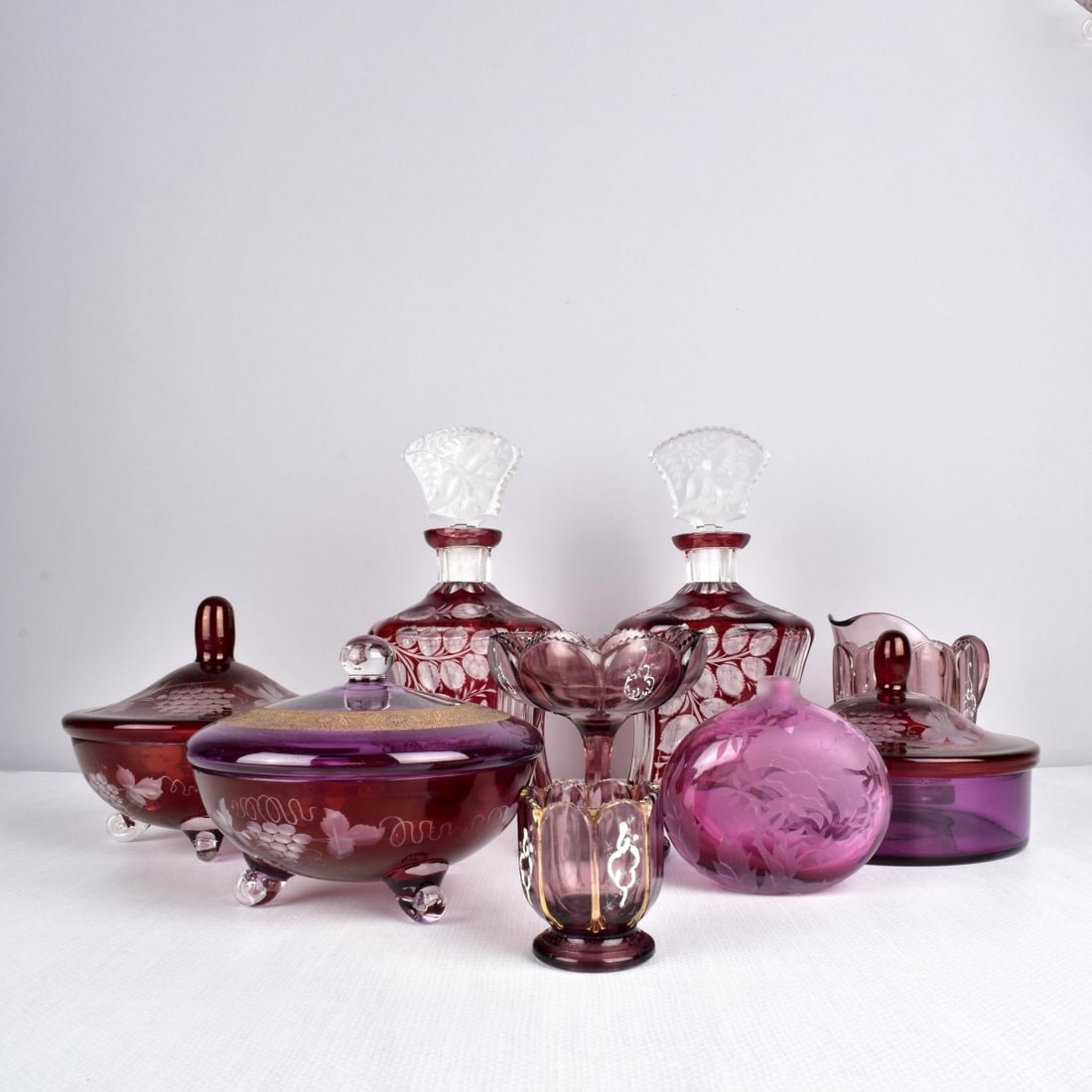 Antique Assortment of Cranberry Glass: Antique Assortment of Nine (9) Pieces of Cranberry Glass, Late 20th century. Consisting of three (3) etched covered candy dishes, one (1) small creamer, one (1) small open candy dish, one (1) tooth pi