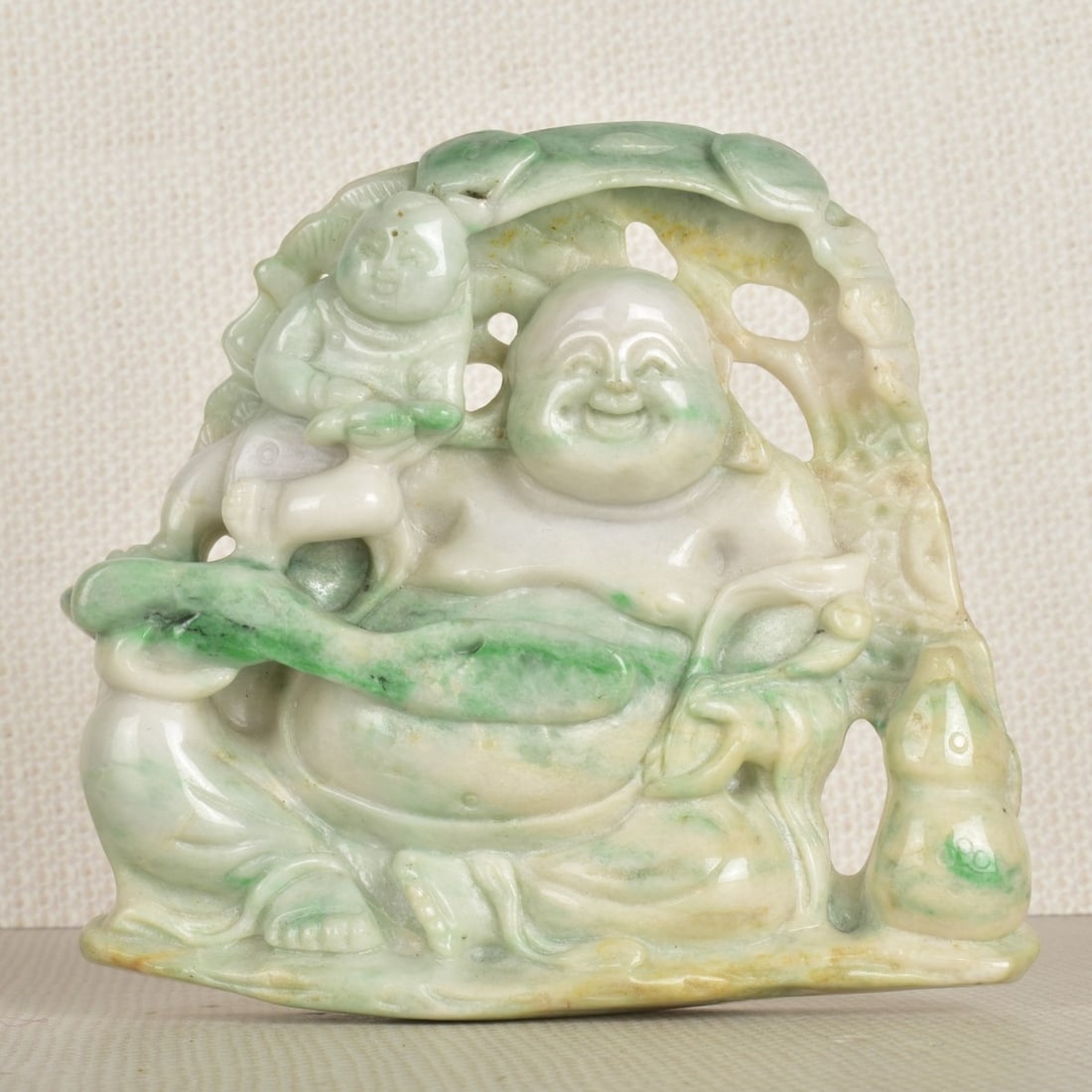 Carved Chinese Jade Figure: Carved Chinese White to Celadon Green Jade Figure of a Smiling Buddah. 20th century. Figure measures: 4" H, 4-1/2" W, 7/8" D. Condition: Good condition. Estimate: $150.00 - $300.00 In-House Shipping: