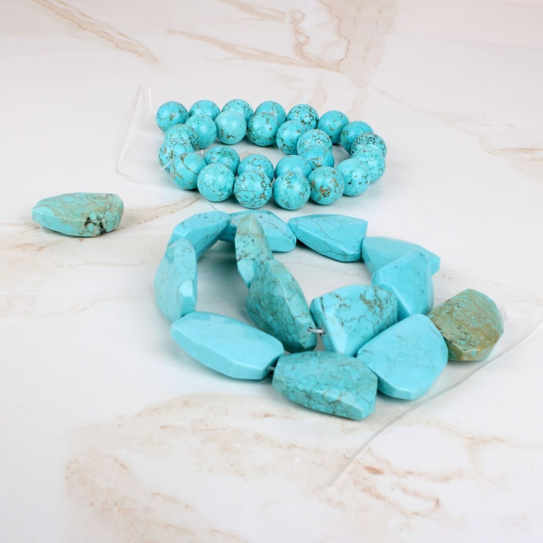 Turquoise Beads: Drilled Turquoise Beads. To include round and irregular shapes. Round beads measure 16mm. Irregular beads measure approx. 30 x 22.5mm. Provenance: former South Florida jewelry designer / maker. Condit