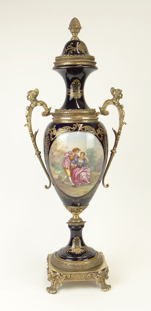 Large 20th Century Sevres-style Gilt Bronze Mounted Por: Large 20th Century Sevres-style Gilt Bronze Mounted Porcelain Covered Urn with Painted Romantic Scene Reserve. Artist Signed Renzi to Reserve. Minor Pitting to Gilt Bronze Base Otherwise Good Conditio