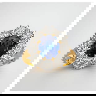 Sapphire, Diamond and 14K Ring: Antique Sapphire, Diamond and 14 Karat Yellow and White Gold Cluster Ring. Set in the center with an approx. .80 carat oval shape dark blue sapphire and with .65 carat TW eight round cut diamonds. Sap
