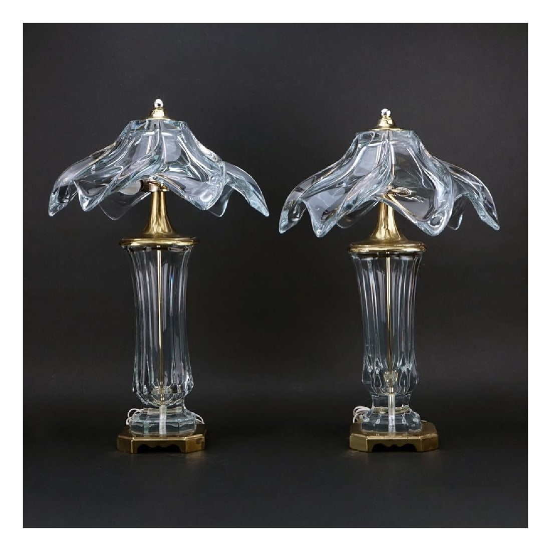 Pair of Murano Lamps: Pair of Mid Century Murano Venini Glass and Brass Lamps. Faceted glass vase with swirl form shade. Measures 24" H. Kodner Galleries offers phone and absentee bidding at a low, flat 21% buyer’s premi