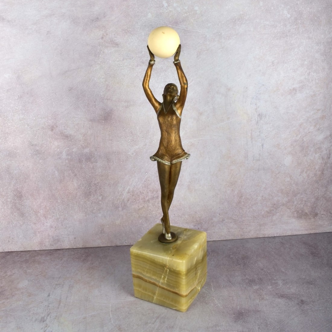 Demetre Chiparus, Romanian (1886–1947): Demetre Chiparus, Romanian (1886–1947) Polychrome Bronze Sculpture, "Ball Girl" on a Green Onyx Base. Signed "Chiparus" in the cast. Figure measures: 14-3/4" H, 3" W, 2-1/2" D. Base measures: 4" H,