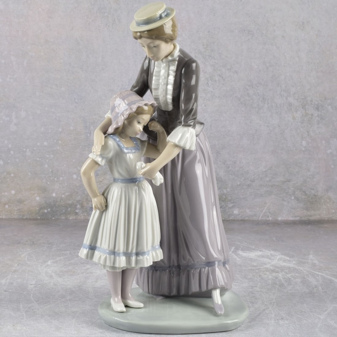 Lladro Spain "Solace" Figurine: Lladro Spain "Solace" Gloss Porcelain Figurine. Signed with LLADRO backstamp. Measures:10-1/2" high, 5-1/2" wide, 4 1/2" deep. Kodner Galleries offers phone and absentee bidding at a low, flat 21% buy
