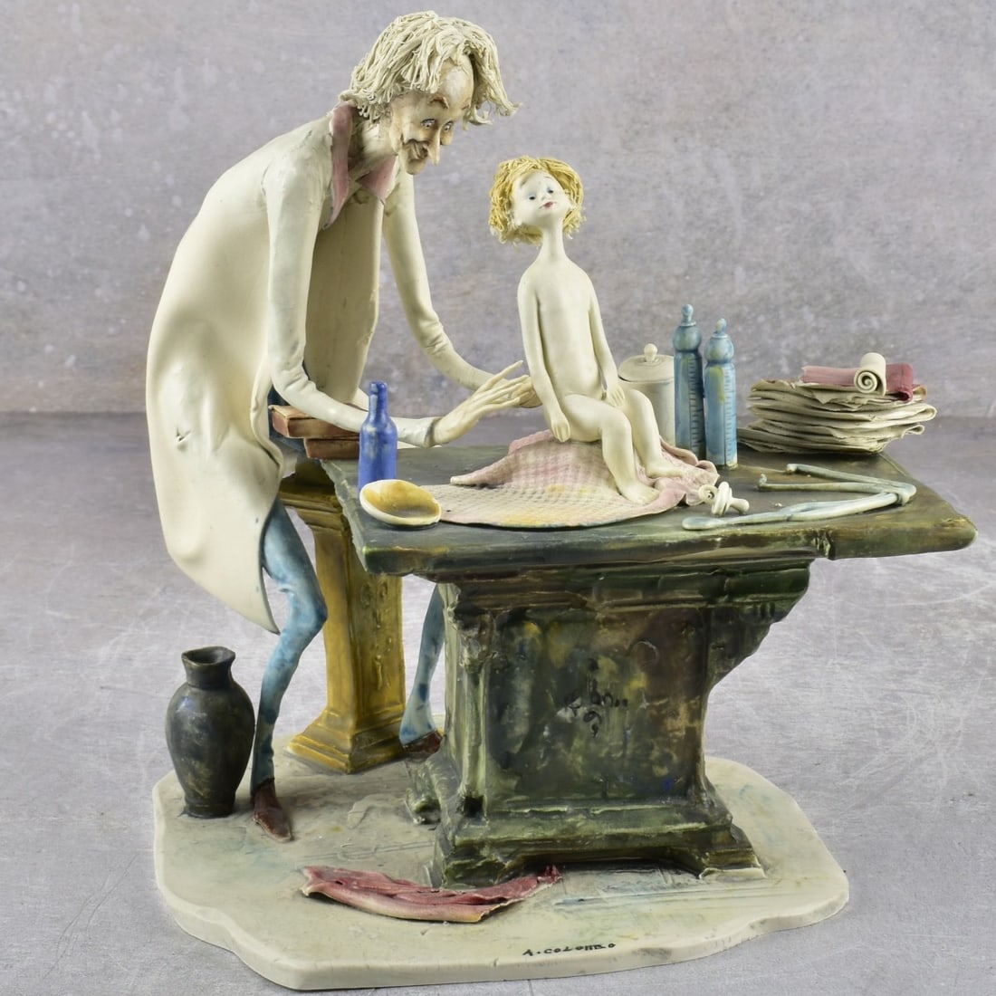 Lo Scricciolo Italy Ceramic Sculpture: Vintage A. Colombo Lo Scriccilo Italy, Active 1958-1993. Ceramic sculpture of a pediatrican and child patient. Artist signed and impressed Lo Scricciolo ITALY to the base. Measures: 8" high, 8" wide,
