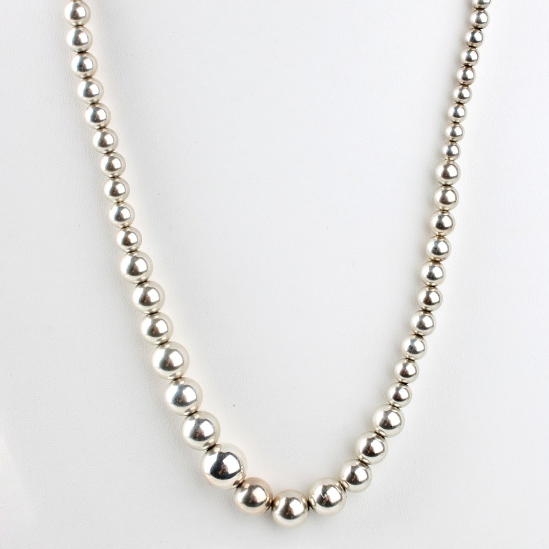 Silver Bead Necklace: Vintage 4.0-14.0mm Graduated Silver Bead Necklace. Necklace measures 29" L. Approx. weight: 40.82 grams. Condition: Good vintage condition. Estimate: $100.00 - $300.00 In-House Shipping: $40.00
