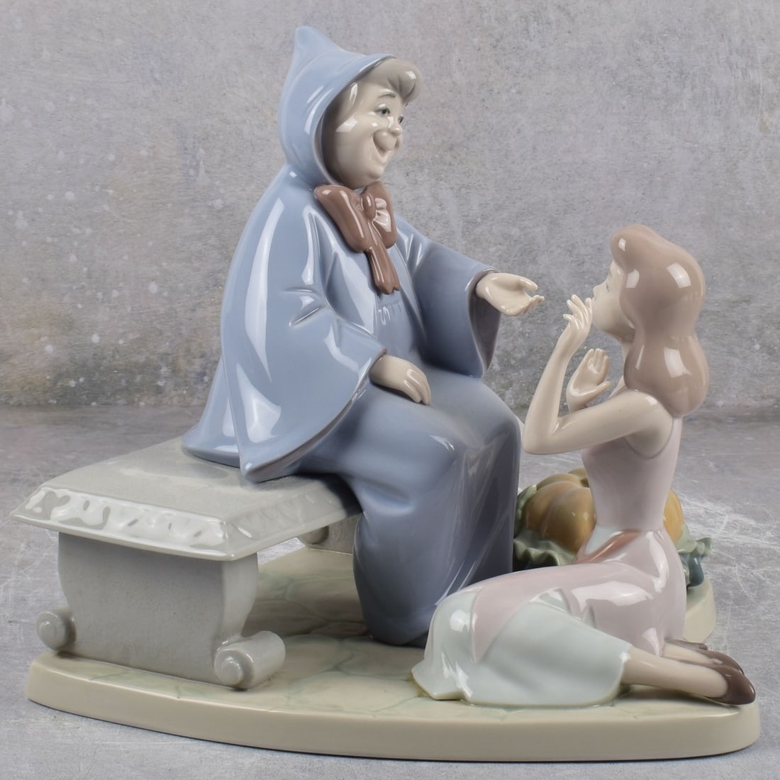 Lladro Spain "Cinderella and Godmother": Lladro Spain "Cinderella and Godmother" Gloss Porcelain Sculpture. Signed, dated "10-12-94" and numbered "319/2,500. Measures: 8-1/4" high, 8" wide, 9" deep. Kodner Galleries offers phone and absentee