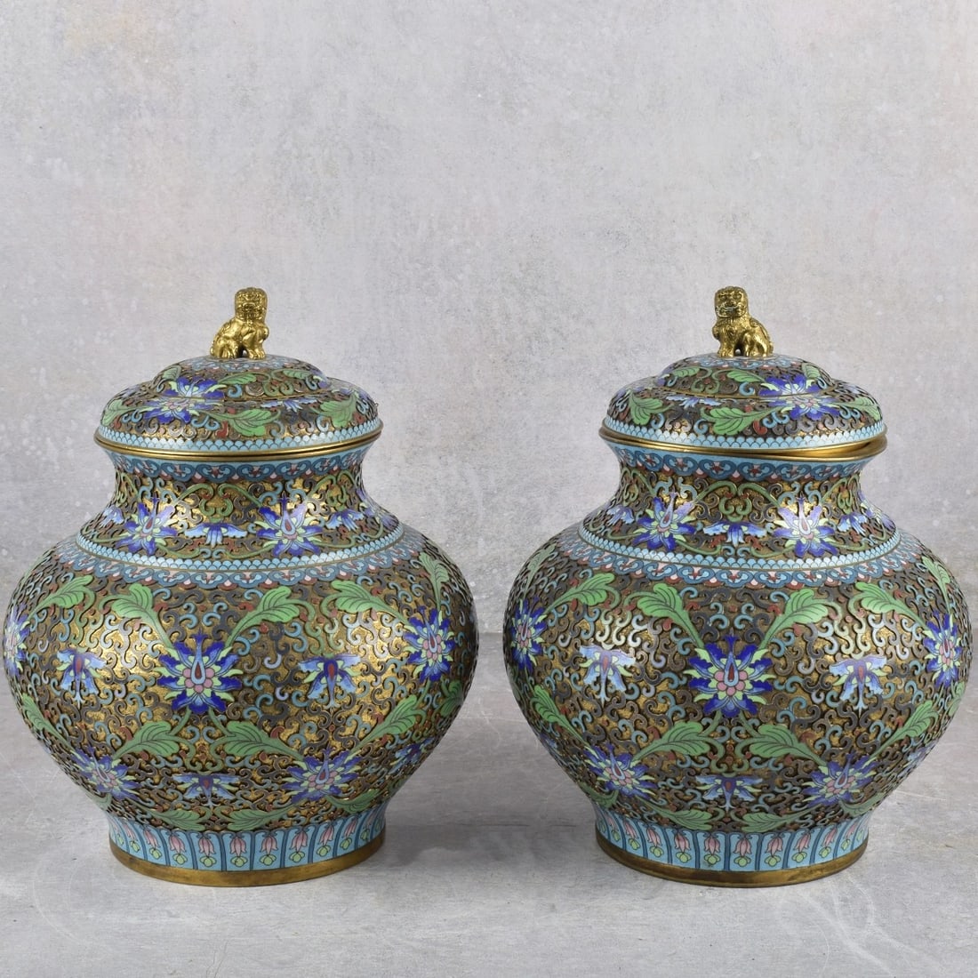 Pair of Antique Chinese Cloisonne Jars: Antique Pair of Chinese Cloisonne Jars with Lids Having Gilt Foo Dog Lion Finials. Measures: 10-1/4" high, 8" diameter. Kodner Galleries offers phone and absentee bidding at a low, flat 21% buyer’s