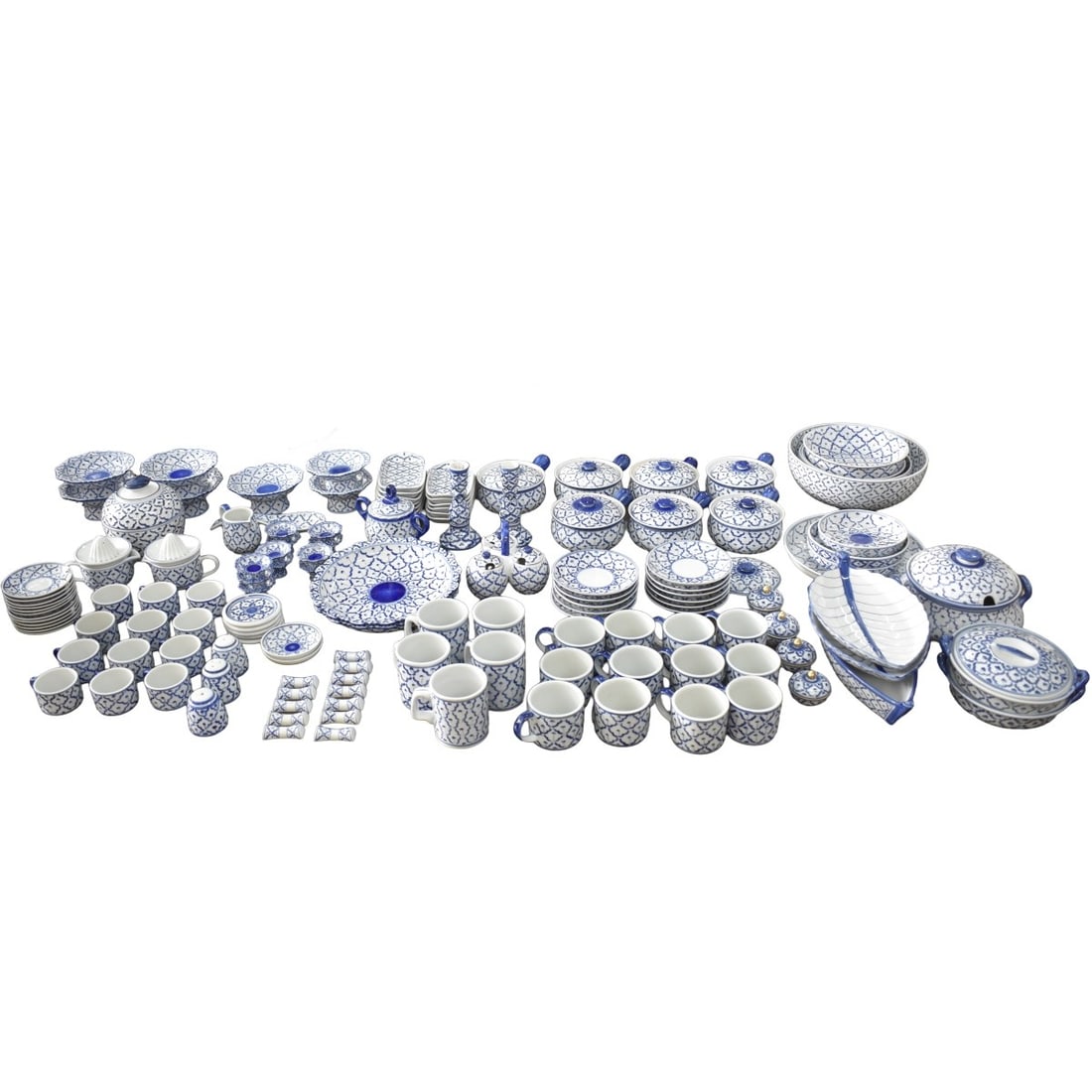 Thai Blue and White Porcelain Serving Pieces: One Hundred-seven (107) Pieces of Thai Blue and White Porcelain Serving Pieces. Consisting of 12 tea cups, 12 saucers, 12 coffee cups, 11 saucers, 5 mugs, 7 covered soup bowls with handles, 13 rectang
