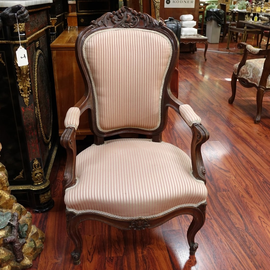 French Louis XV Style Fauteuil Armchair: Early 20th Century French Louis XV Style Wood Carved and Upholstered Fauteuil Armchair. Floral relief carved on frame, and stands on cabriole legs. Measures 41" H x 24" W. Kodner Galleries offers phon