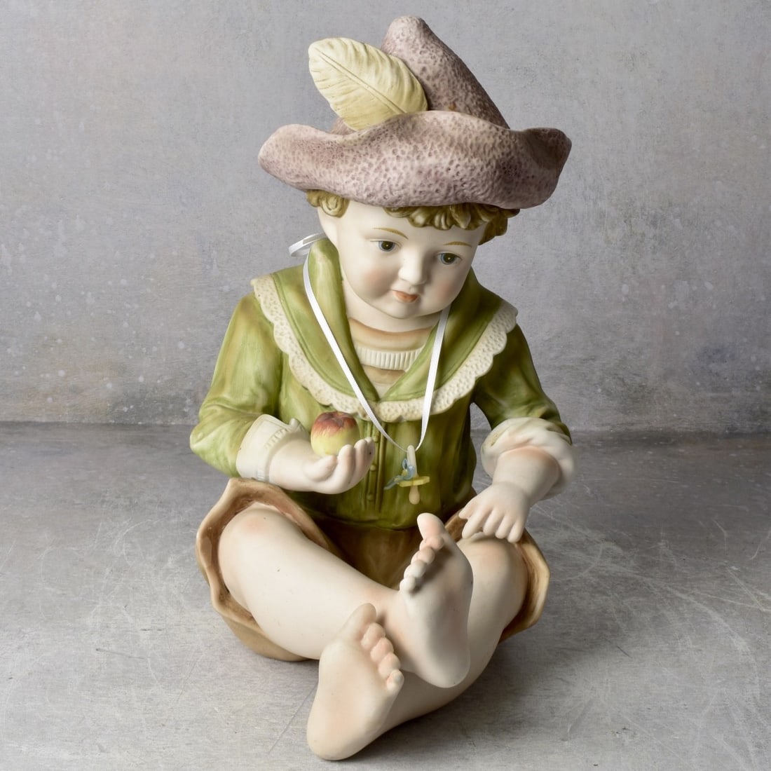 Vintage German Bisque Piano Baby Boy: Vintage Large German Bisque Piano Baby Boy Holding Apple. Signed to the bottom. Measures: 13" high, 7-3/4" wide, 9-1/2" deep. Kodner Galleries offers phone and absentee bidding at a low, flat 21% buye