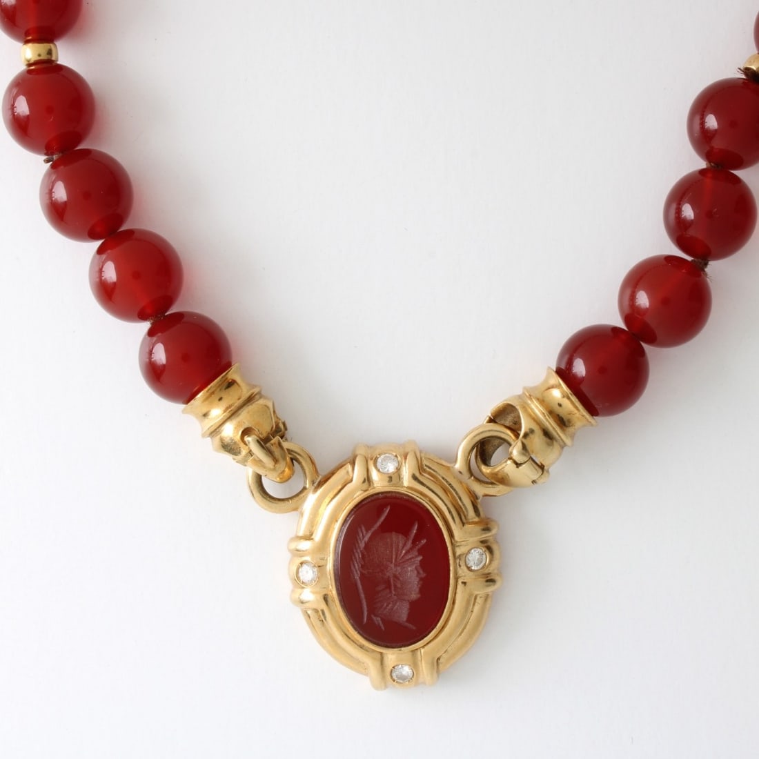 Carnelian, Diamond and 14K Necklace: Vintage 10mm Carnelian Bead and 14 Karat Yellow Gold Necklace with Carved Carnelian Cameo, Round Brilliant Cut Diamond and 14 Karat Yellow Gold Pendant. Measures 16" L, 1" pendant drop. Approx. weight