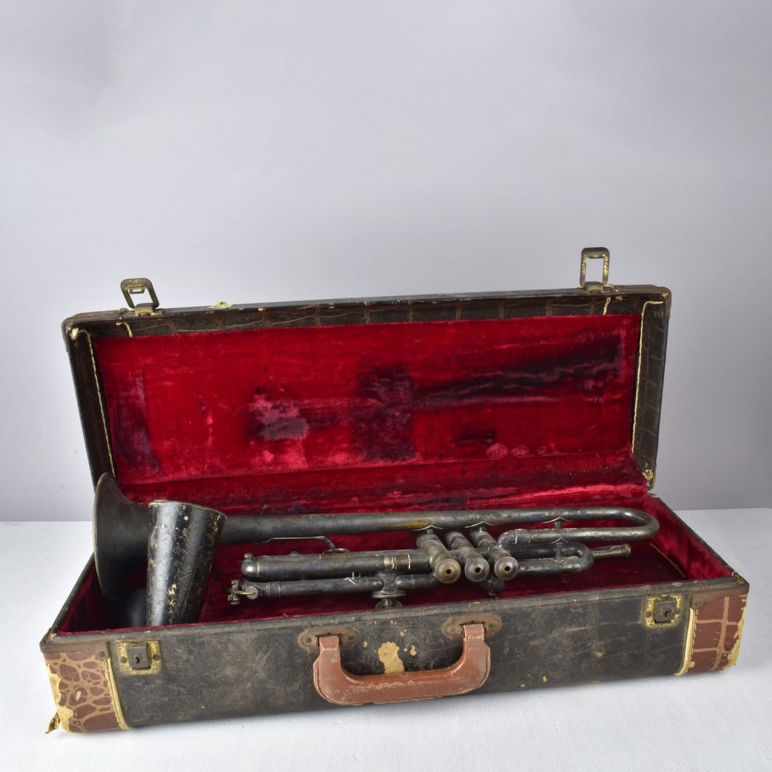 Silver Plate Trumpet with Case: The Vega Company, Boston, Massachusetts Silver Plate Trumpet with Case and Mute. Stamped "Vega Standard Boston Pat., 1914". Measures: 19-1/2" H, 5 1/2" W, 4-3/4" D. Kodner Galleries offers phone and a