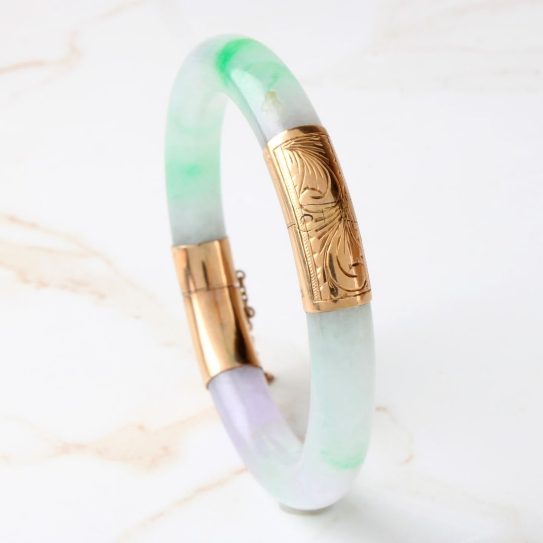 Jade and 14K Bracelet: Fine Vintage Chinese Lavender to Celadon Green Jade and 14 Karat Yellow Gold Hinged Cuff Bangle Bracelet. Measures 7" interior circumference. Approx. weight: 49.90 grams. Kodner Galleries offers phone