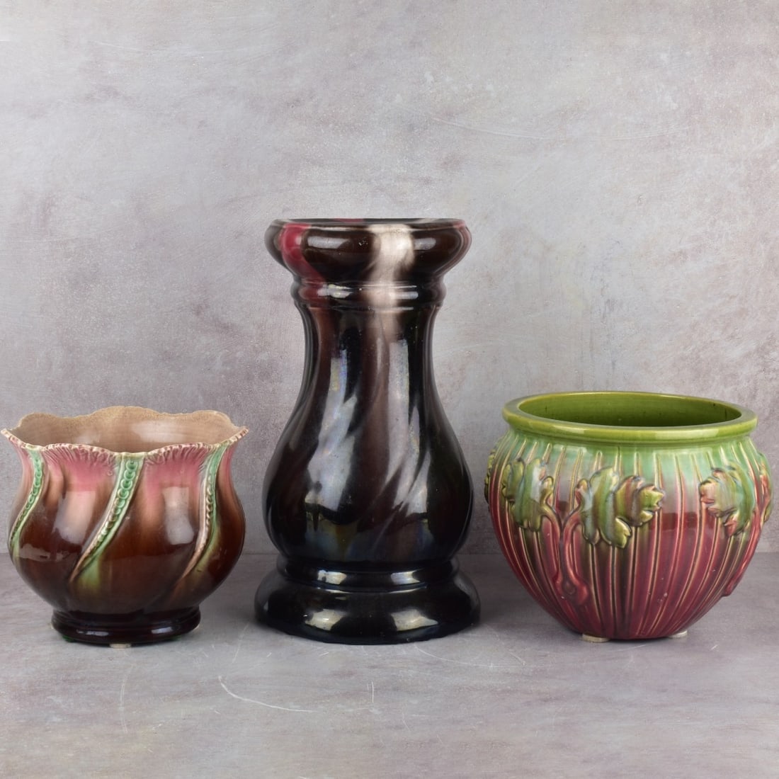 Majolica Pedestal and Jardinieres: Majolica Art Nouveau Style Pedestal and Jardinieres. Consisting of a black amethyst pedestal, measures: 14-3/4" high, 8-1/2" diameter, rose green amethyst jardiniere, measures: 7-3/4" high, 8-3/4" dia