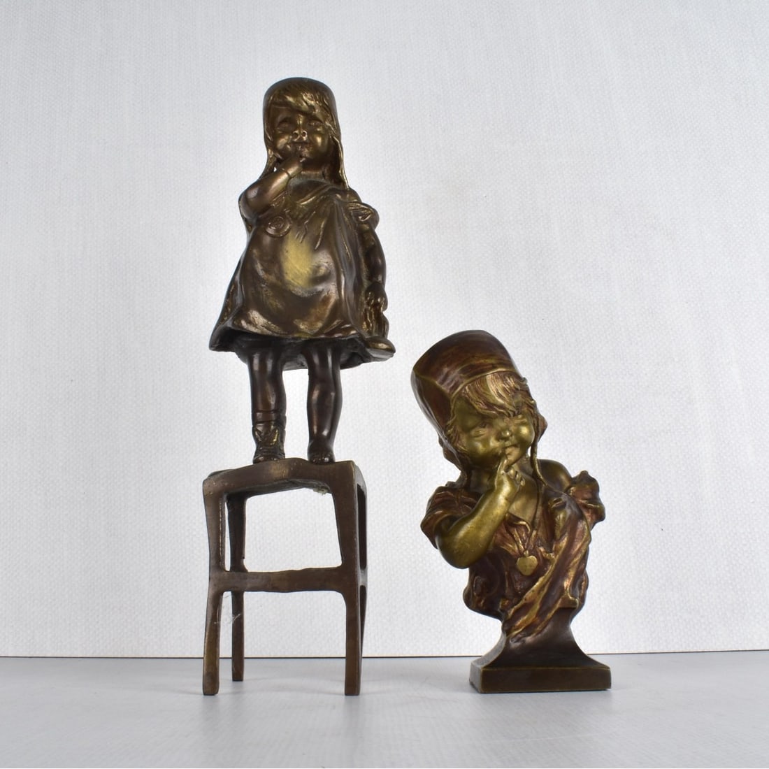Juan Clara, Spanish (1875-1958): Juan Clara, Spanish (1875-1958). Two (2) "Suzette" Bronze Figures. One (1) figure of the young infant girl on a stool. Unsigned. One (1) figure of the young infant girl looking down. Signed. Tallest m