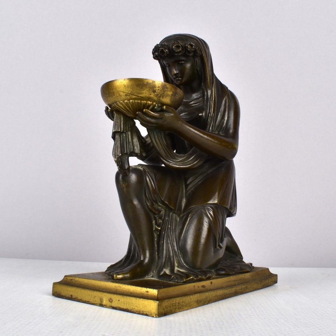 Bronze Lady Kneeling with Bowl: Bronze Lady Kneeling with Bowl Offering Gilt bowl with gilt base. unsigned but bowl has an ILE stamped inside. Measures 6-3/4" H x 5-1/2" W x 3" D. Kodner Galleries offers phone and absentee bidding a