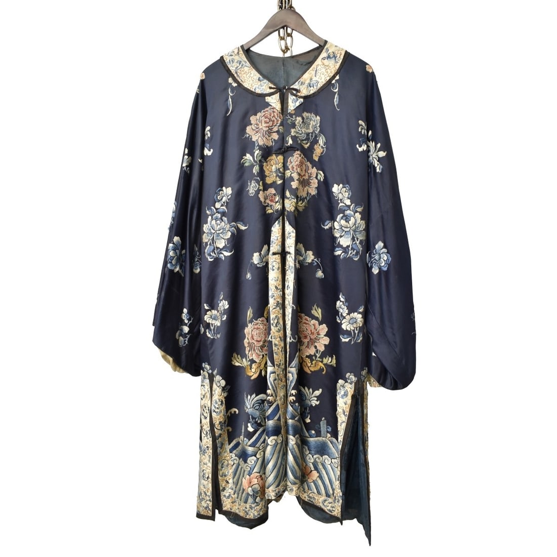 18/19C Chinese Silk Embroidered Robe: 18/19th Century Chinese Multi-Colored Blue Silk Embroidered Robe. Decorated floral patterns with scrolling sea. Round neck panel, fastening down the front, measures 65" L, sleeve to sleeve 49" W, unde
