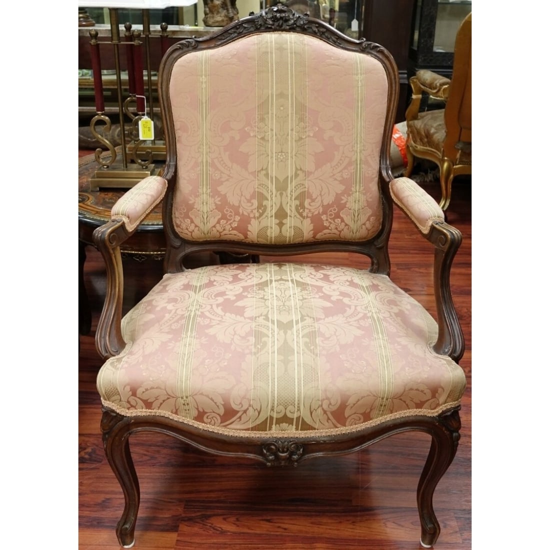 Louis XV Style Carved Fauteuil Armchair: Early 20th Century French Louis XV Style Carved and Upholstered Fauteuil Armchair. Carved foliage top and apron, Kodner Galleries offers phone and absentee bidding at a low, flat 21% buyer’s premium