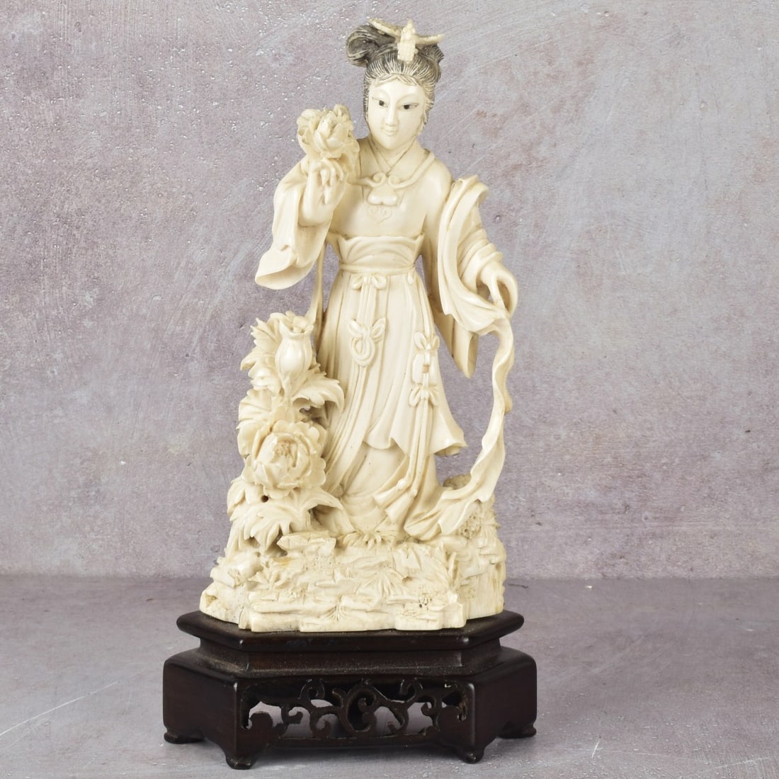 Chinese Carving of a Guanyin: Antique Chinese Polychrome Carving of a Guanyin with Abundance of Flowers. Unsigned. Without base measures: 7-1/4" high, 2-1/2" wide, 2-1/4" deep. We Will Not Ship This Item Outside of the State of Fl