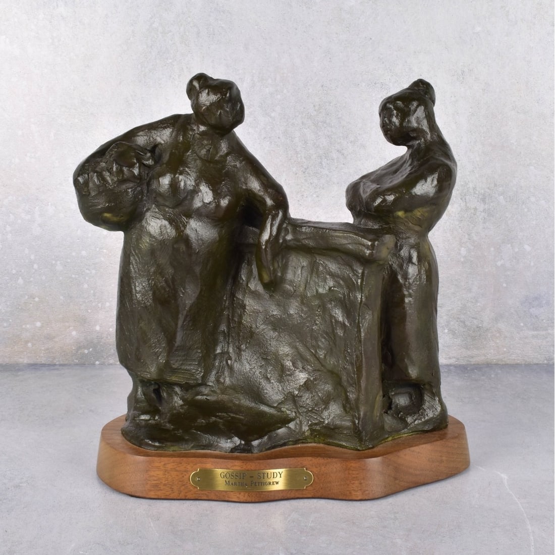 Martha Pettigrew Bronze Sculpture: Martha Pettigrew Bronze Sculpture "Gossip Study". Bronze sculpture mounted on wood base with title plate. Measures10" H., 9-1/2" W., 5-1/2" D. Kodner Galleries offers phone and absentee bidding at a