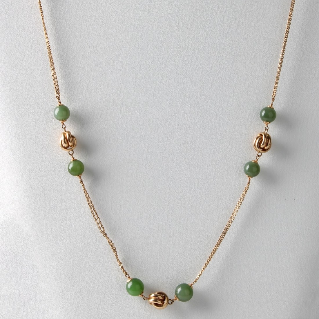 Jade and 14K Necklace: Vintage 9.0mm Nephrite Jade Bead and 14 Karat Yellow Gold Long Necklace. Measures 32" L. Approx. weight: 34.69 grams. Kodner Galleries offers phone and absentee bidding at a low, flat 21% buyer’s