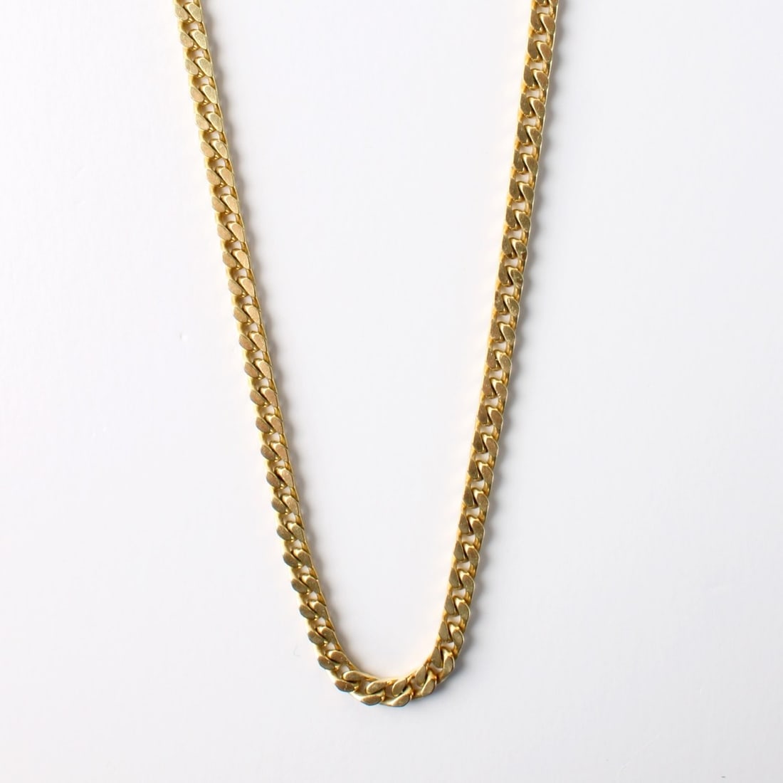 10K Necklace: Vintage Long 10 Karat Yellow Gold Cuban Link Necklace. Measures 32" L. Approx. weight: 36.49 grams. Kodner Galleries offers phone and absentee bidding at a low, flat 21% buyer’s premium without