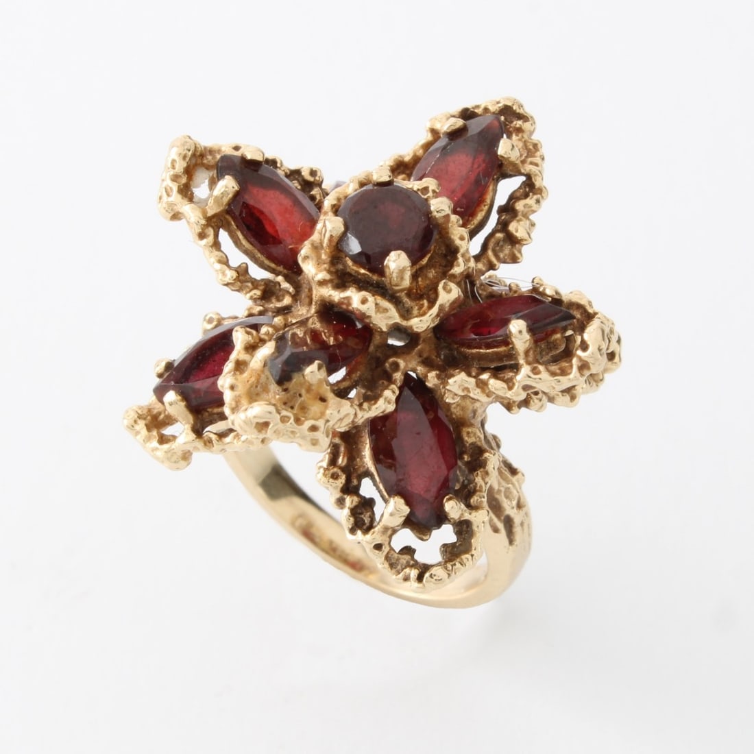 Garnet and 14K Ring: Retro Circa 1960s Marquise and Round Cut Garnet and 14 Karat Yellow Gold Starburst Cluster Ring. Stamped 14K. Ring size 5. Approx. weight: 10.65 grams. Kodner Galleries offers phone and absentee