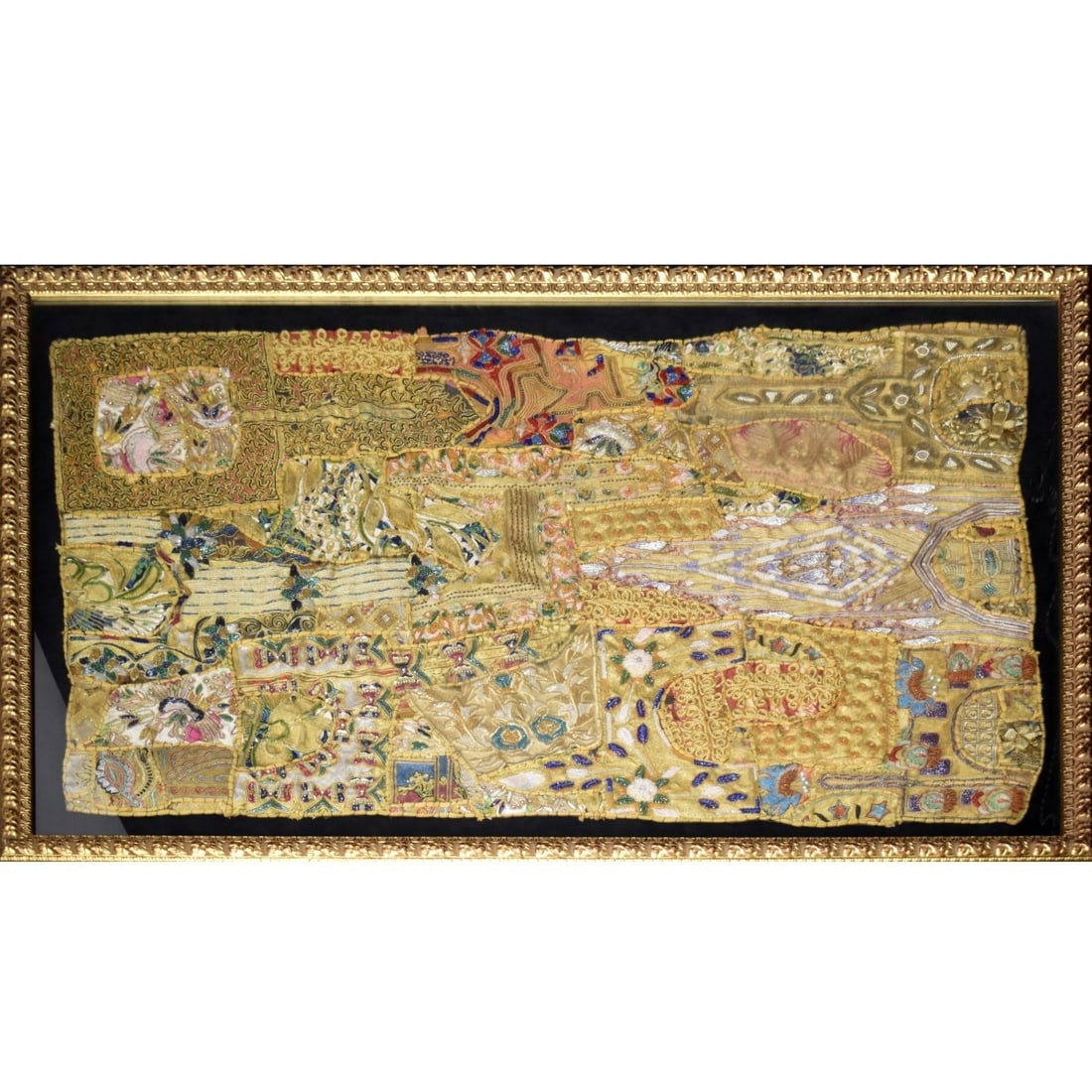 Indian Textile Wall Tapestry: Fine Antique Indian Jeweled Hand Embroidered and Beaded Jeweled Textile Wall Tapestry Decorated Throughout with a Foliate Design. Framed under Plexiglass. Tapestry measures: 56-1/2" high, 36" wide,