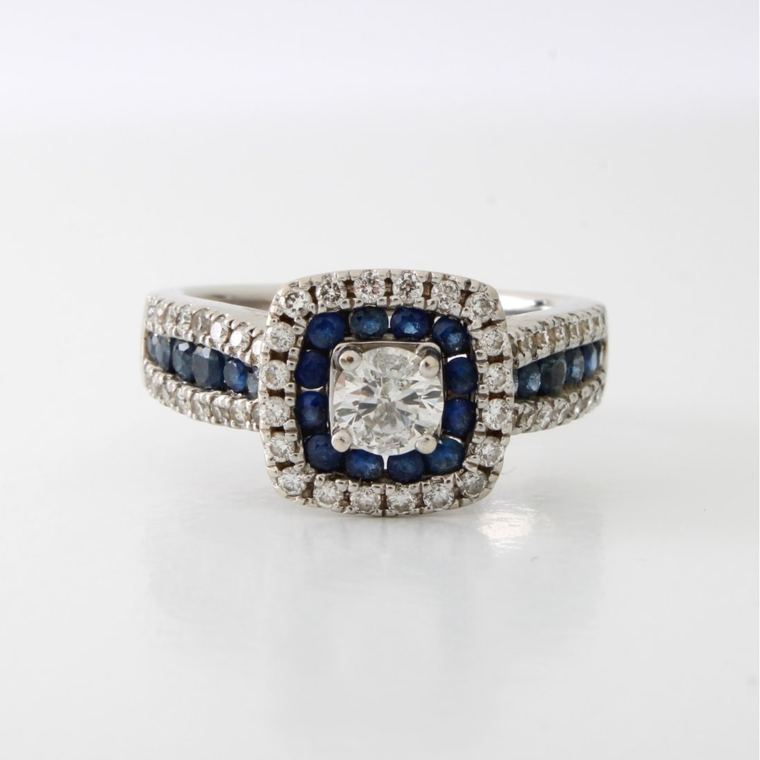 Diamond, Sapphire and 14K Ring: Vintage Diamond, Sapphire and 14 Karat White Gold Ring. Set in the center with an approx. .42 carat round brilliant cut diamond G color, I1 clarity and measuring 4.6 x 3.2mm. Accented with approx.