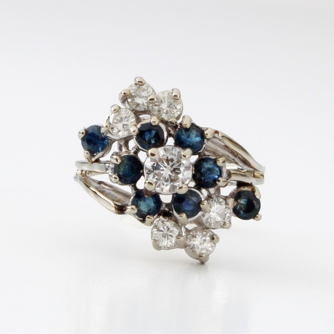 Diamond, Sapphire and 14K Ring: Vintage Fine Quality Approx 1.45 Carat TW Round Brilliant Cut Diamond, Sapphire and 14 Karat White Gold Ring. Set in the center with an approx. .55 carat round brilliant cut diamond measuring 5.35 x