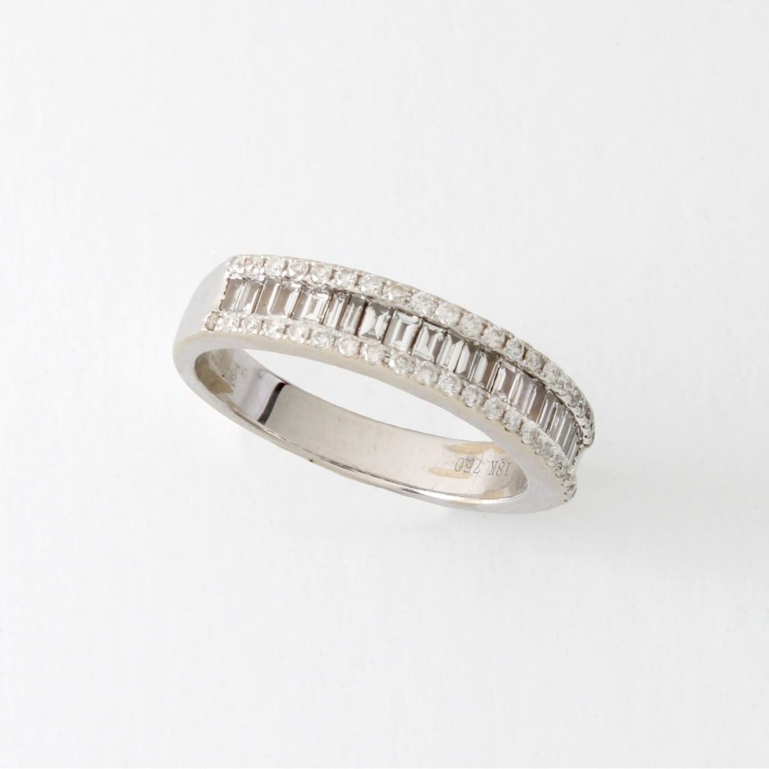 Diamond and 18K Ring: Fine Vintage Approx. 1.0 Carat TW Baguette and Round Brilliant Cut Diamond and 18 Karat White Gold Band / Ring. Diamonds F-G color, VS1 clarity. Ring size 5-1/2. Approx. weight: 4.07 grams. Kodner Gal