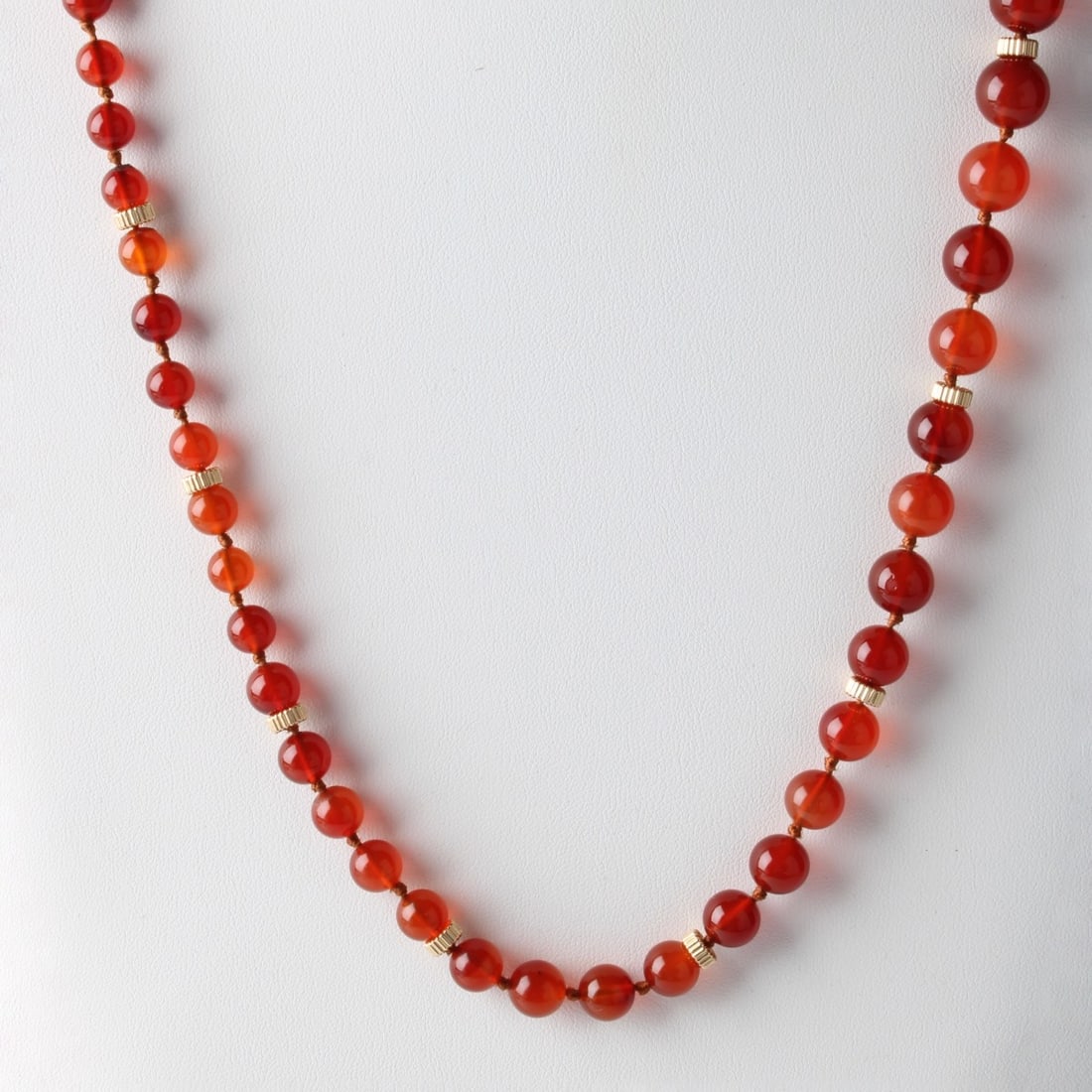 Carnelian, Chrysoprase and 14K Necklace: Vintage 8.5-13.5mm Carnelian Bead and 14 Karat Yellow Gold Necklace with Carved Carnelian and Chrysoprase Pendant. Measures 30-1/4" L. Approx. weight: 85.78 grams. Kodner Galleries offers phone and